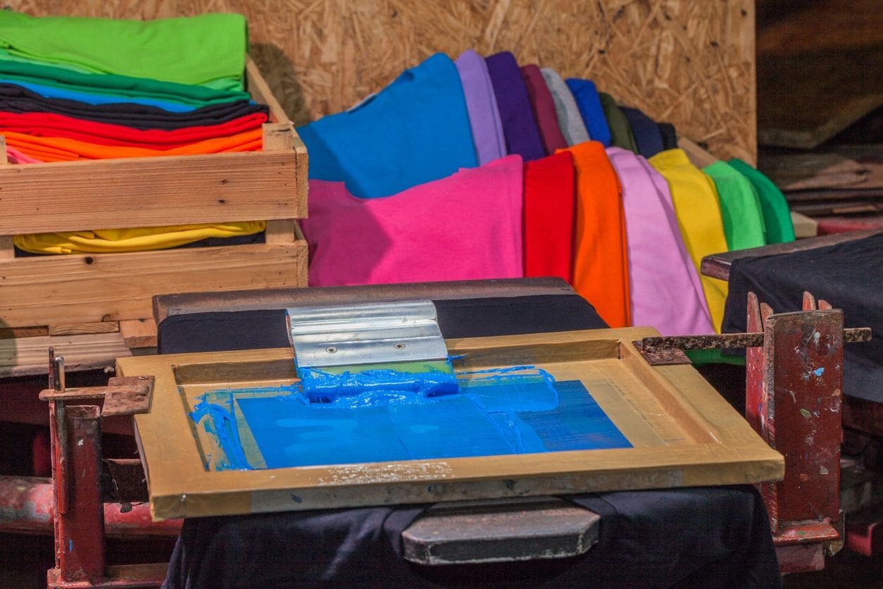 A table with many different colored fabrics on it